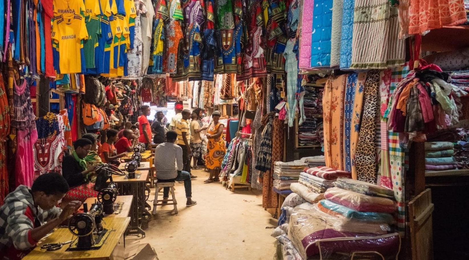 A bustling marketplace where vendors sell fresh produce, traditional crafts, and everyday goods